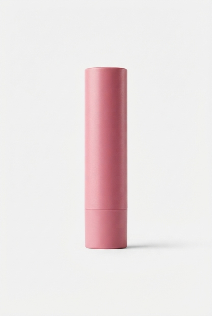 Pink tinted lip shield stick centered on matte off-white background