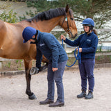 Horse Riders Wearing Helmets While Handling a Horse