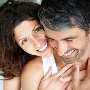 The Benefits of the Menopause. Happy couple smiling and embracing closely, showing affection and intimacy in a bright, relaxed setting