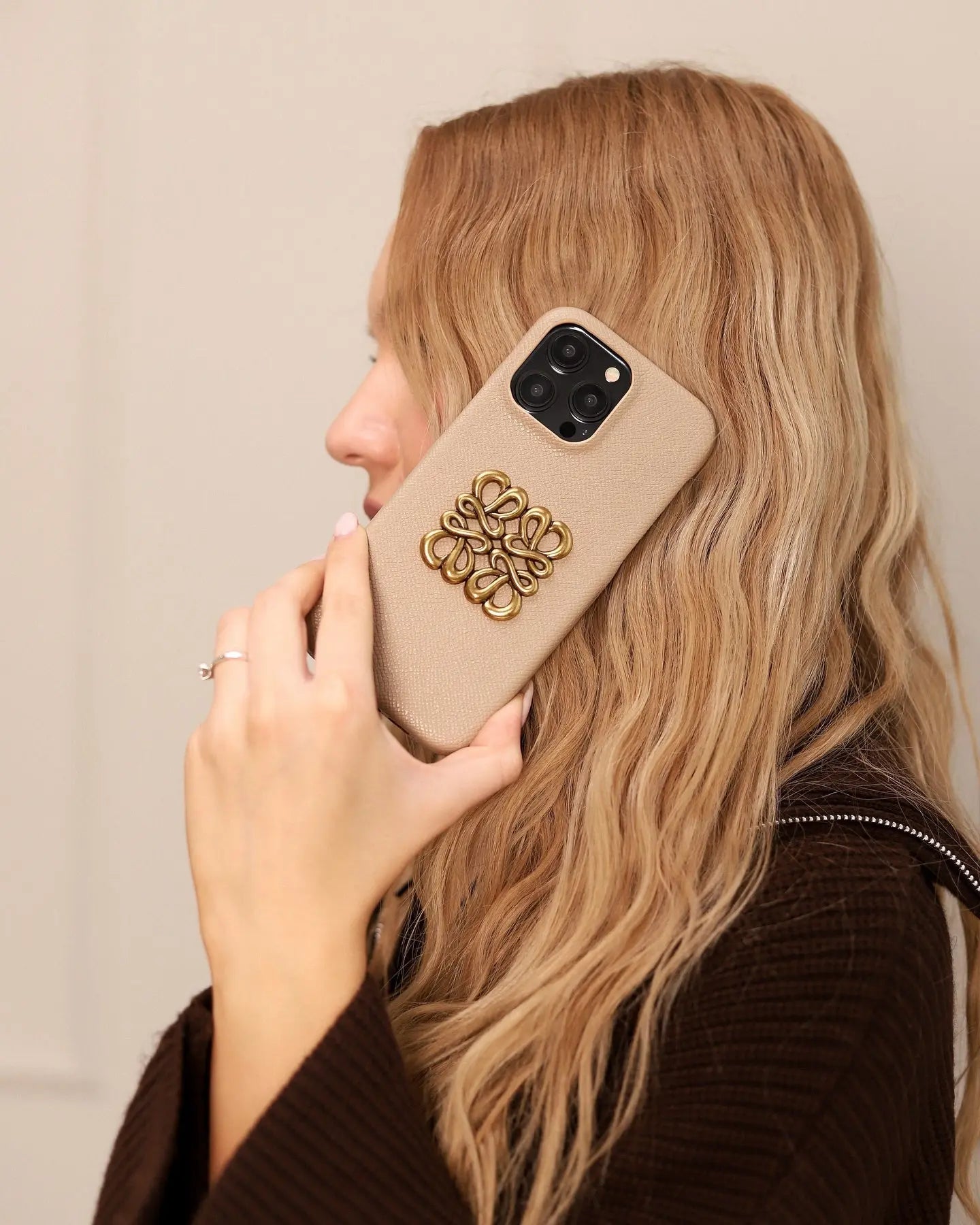 A collage of different luxury iPhone cases, including minimalist, monogram, and crossbody styles, representing various lifestyles.