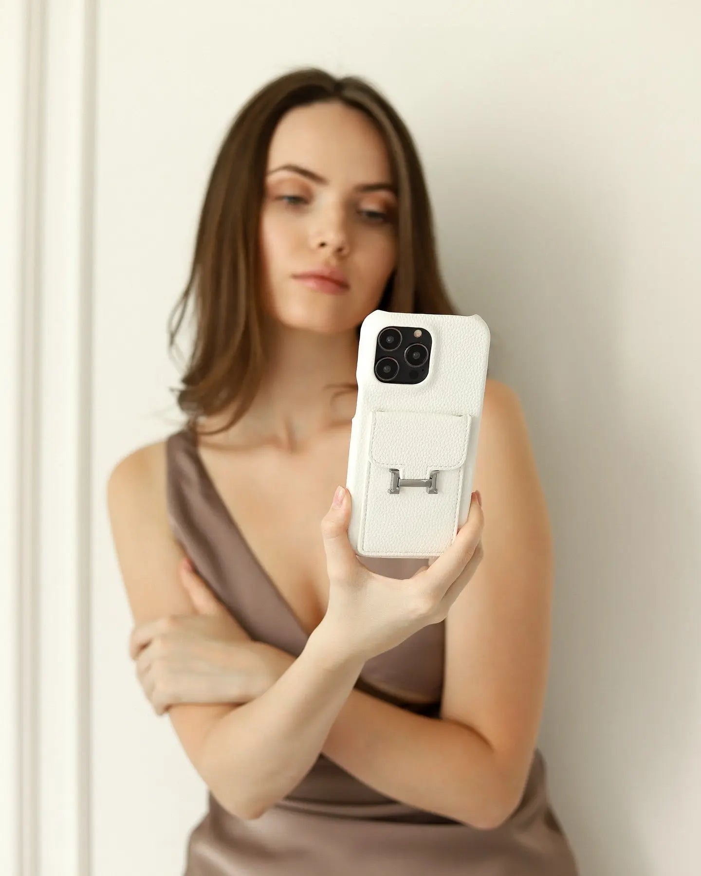 A detailed macro shot of a luxury iPhone case highlighting the flawless stitching, high-quality hardware, and premium material finish.