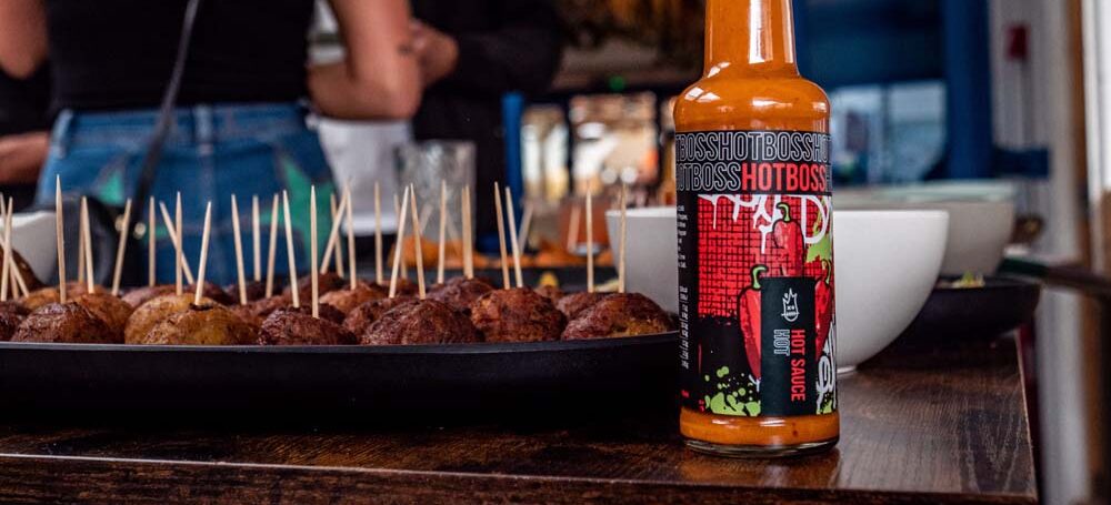 hotboss hot sauce next to food