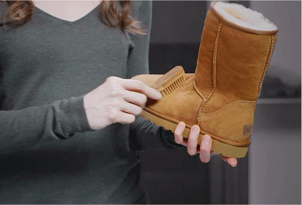 Woman brushing an UGG Classic