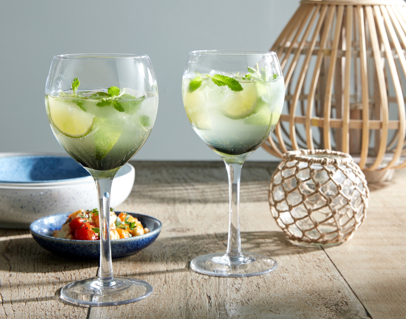 Cocktails with lime and mint garnishes