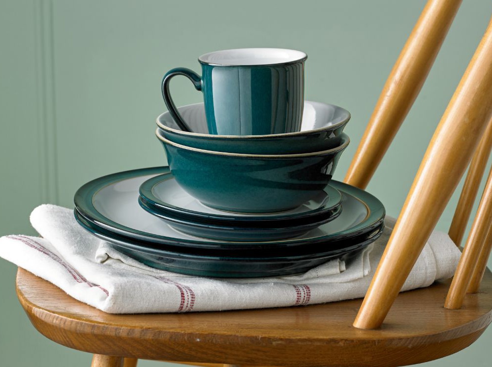 Greenwich plates, bowls, and mug on a wooden chair