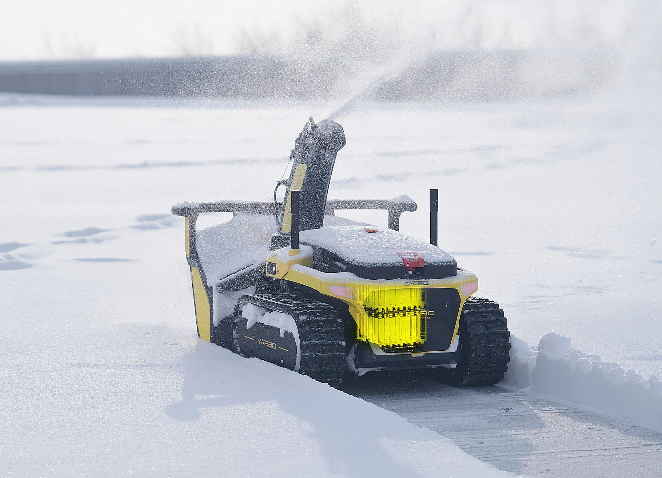 A battery-powered cordless snowblower is clearing snow.