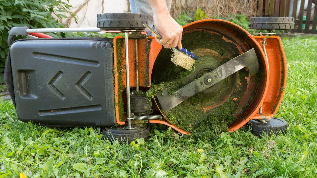 Cleaning the Mower Deck with a Brush