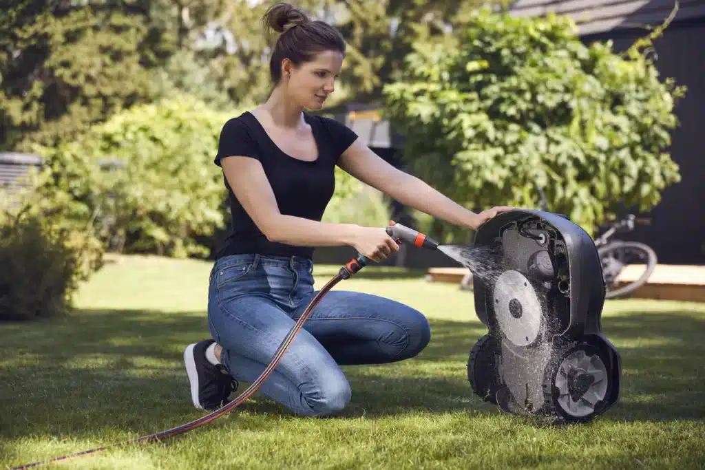 Cleaning a robot lawn mower - Image by plattsrobotics