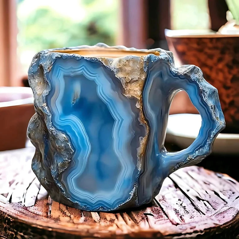 Blue agate crystal-inspired coffee mug with layered stone detailing and a rustic handle.