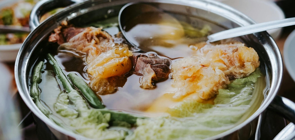 Stock is typically made by simmering bones (with a bit of meat still attached), along with vegetables like onions, carrots, and celery for several hours