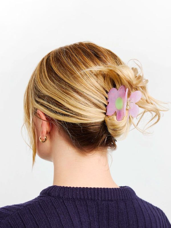 Large claw clip holding thick hair in a half-up twist